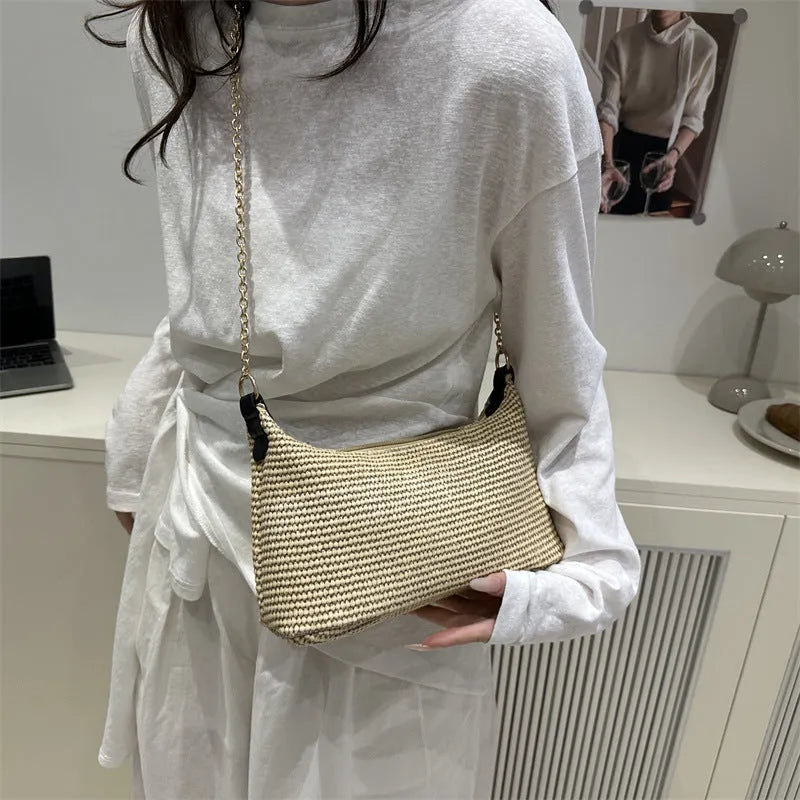 Woven straw shoulder tote bag in a horizontal square shape with a sandwich pocket.