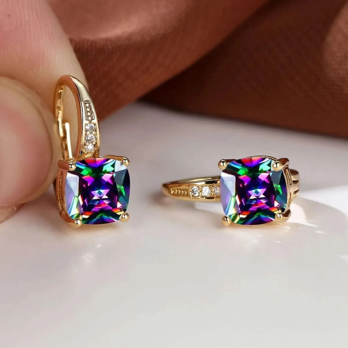 Square geometric ear clips with colourful moissanite inlays and a metallic electroplated finish.
