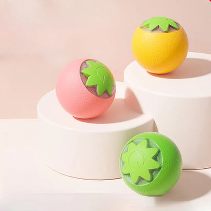 Green automatic rotating ball pet toy for dogs and cats on indoor flooring