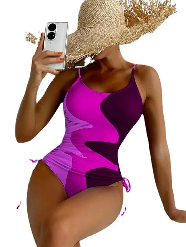 A blue one-piece swimsuit for women, showing sleeveless and backless design on a mannequin.