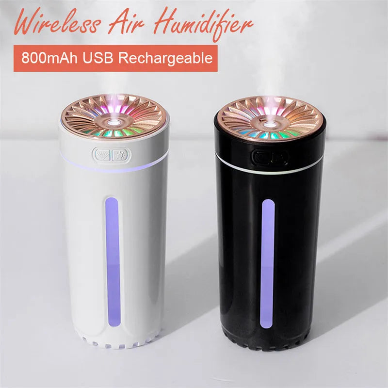 Black wireless car humidifier with colourful LED lights shown in vehicle cup holder