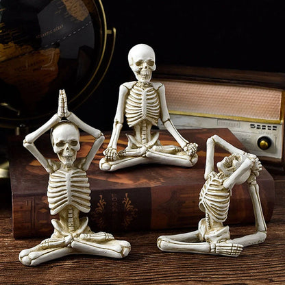 Spooky skeleton desktop decorations featuring intricate resin skulls and skeletons in vintage white and ominous black color options