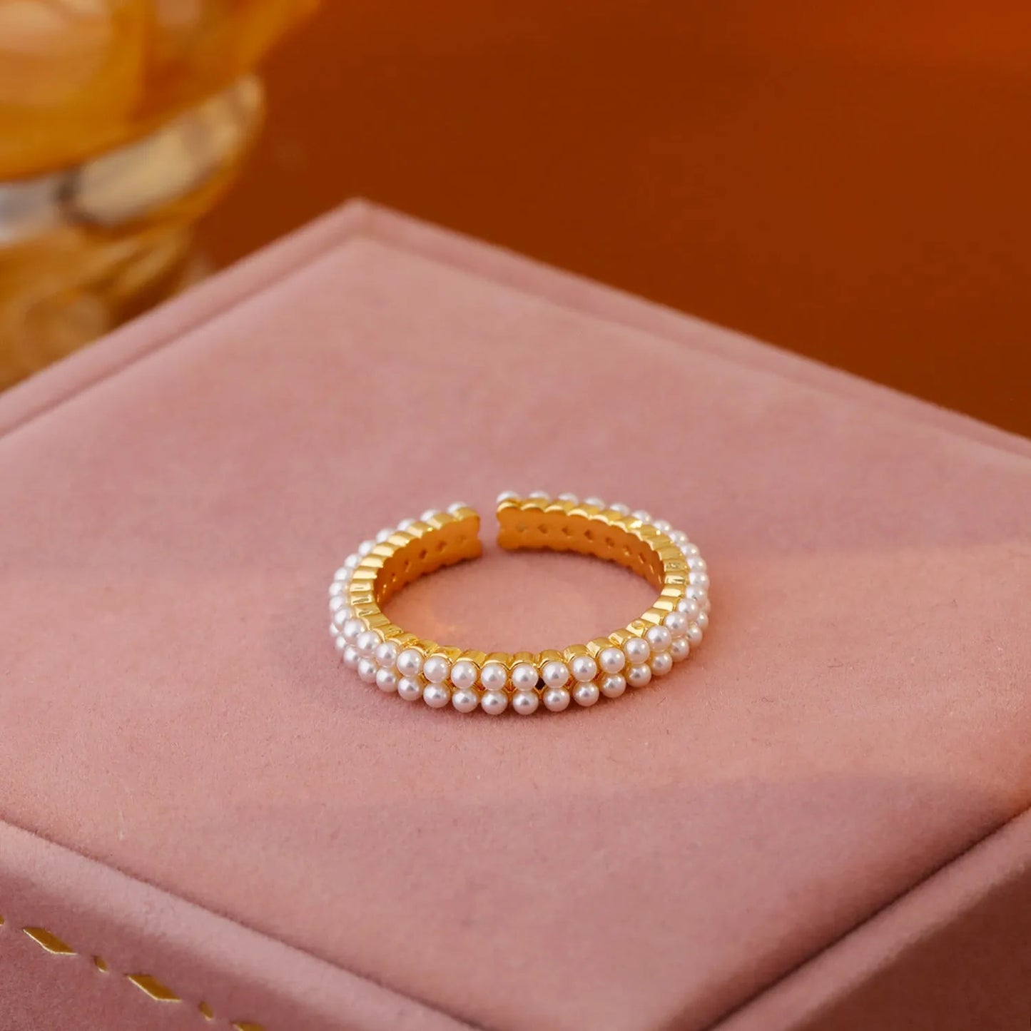 Gold electroplated pearl ring with open mouth geometric design and round pearl elements