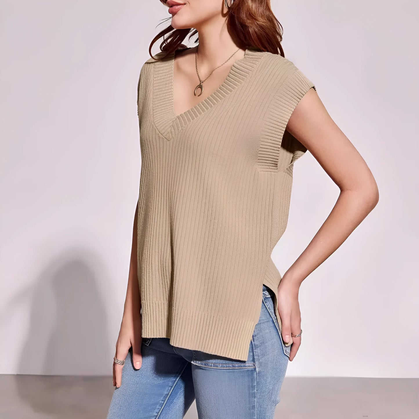 Camel coloured loose v-neck sleeveless vest with a striped pattern on a hanger.