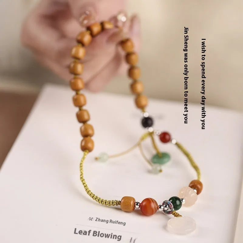 Women's bracelet with original sandalwood hand fragrance design, artistic double ring style featuring ebony and jade materials in national style with Ruyi pattern, hand-woven construction for female wearers in Xiuyan jade or old chalcedony colour options