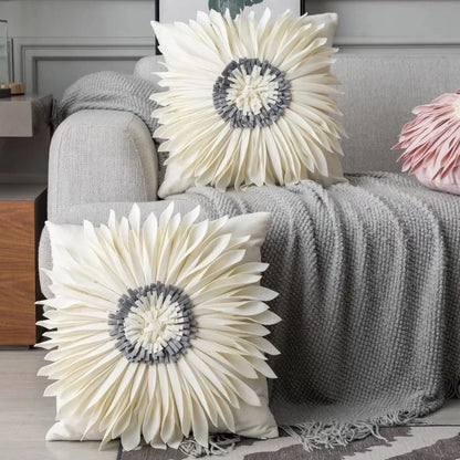 Stylish velvet throw pillows with 3D chrysanthemum embellishments in blue, yellow, pink, and white colors