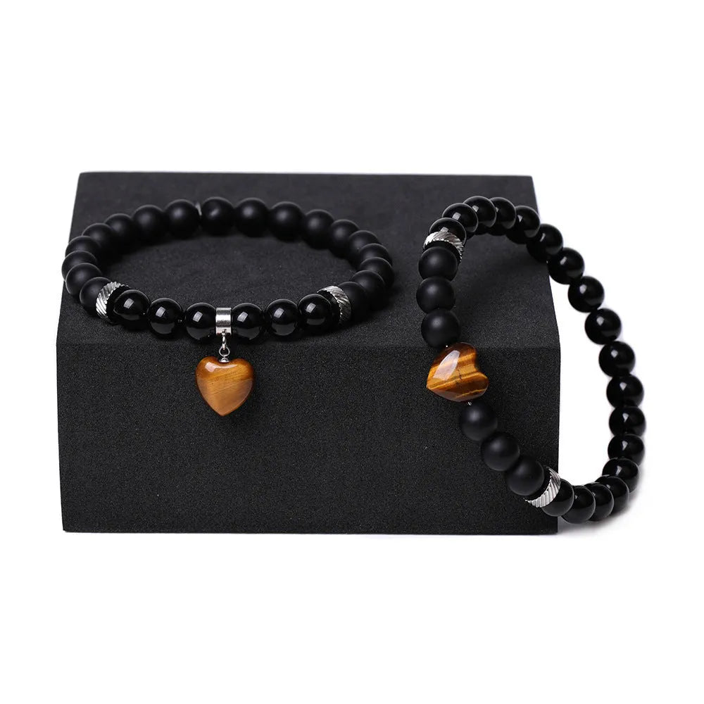 Matching couple bracelets with polished natural stone heart pendants in geometric style