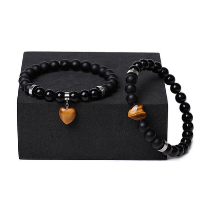 Matching couple bracelets with polished natural stone heart pendants in geometric style