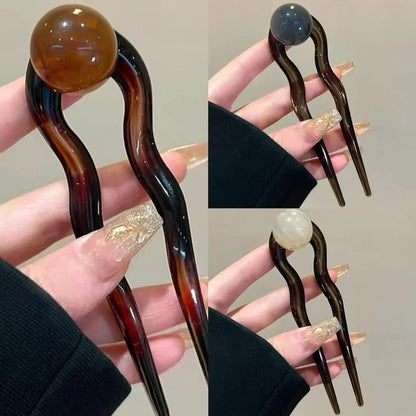 Acrylic U-shaped hair barrette with retro ball design in caramel colour