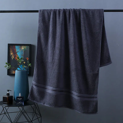 Three-piece cotton towel set showing bath towel, towel, and square scarf in coordinating colours