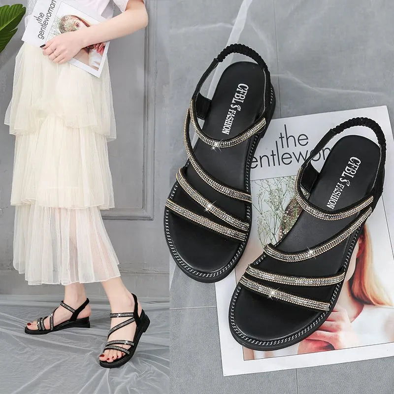 Women's silver sandals with elastic band and sequin accents, showing rubber sole and round toe design