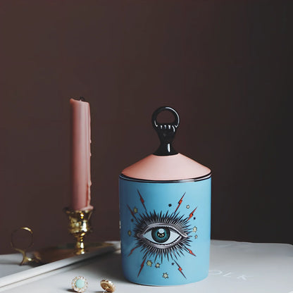 Blue ceramic candle holder with figure decals measuring 15cm high