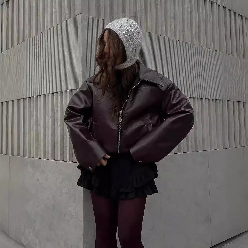 Stylish faux leather jacket with zip-up closure and lapel collar, available in burgundy and black colors