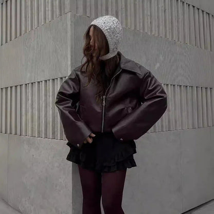 Stylish faux leather jacket with zip-up closure and lapel collar, available in burgundy and black colors