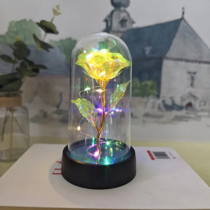 Glass cover small night lamp with plastic flowers, 15cm height, black base, showing colour light options