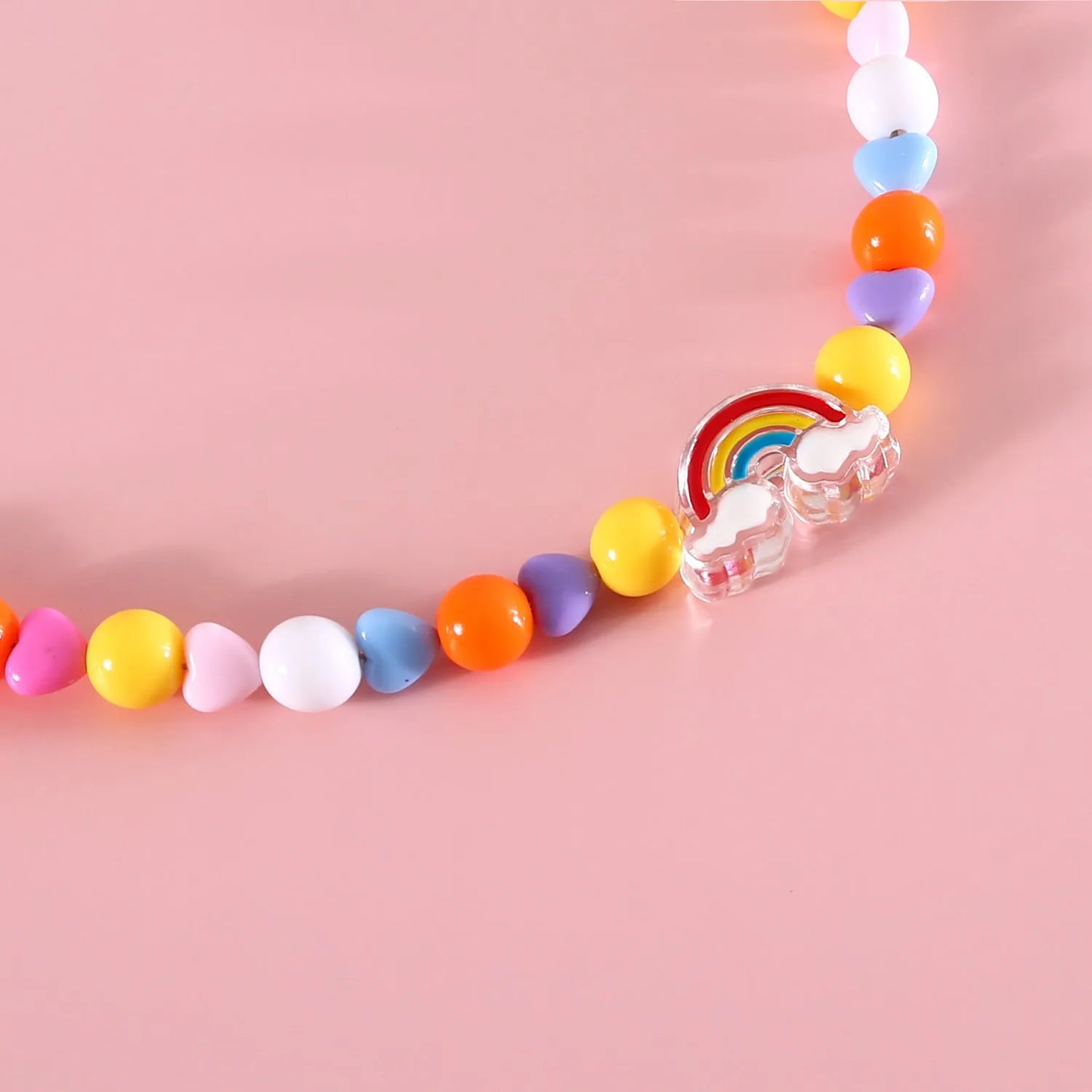 Colourful plastic bead cat necklace with adjustable clasp showing peach, rainbow, and small flower pattern options