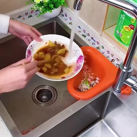 Yellow swan-shaped plastic kitchen drainer basket with drainage holes on kitchen counter