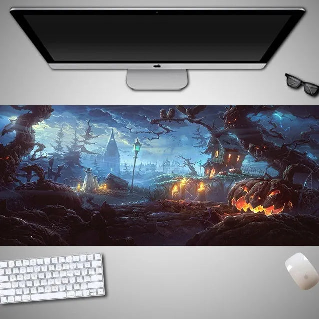 Oversized black Halloween-themed mouse pad with graphic design on a desk with keyboard and mouse