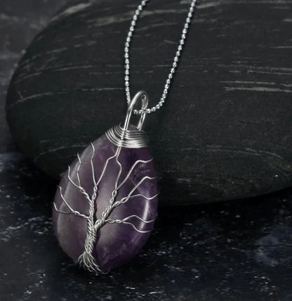 A Celtic Tree of Life pendant necklace made with a teardrop-shaped semi-precious stone and an adjustable chain.