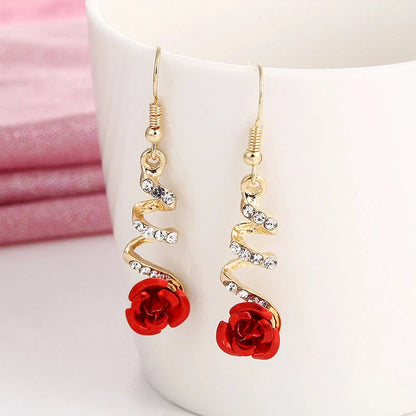 Ethnic red rose drop earrings with big rhinestones in rose gold spiral design