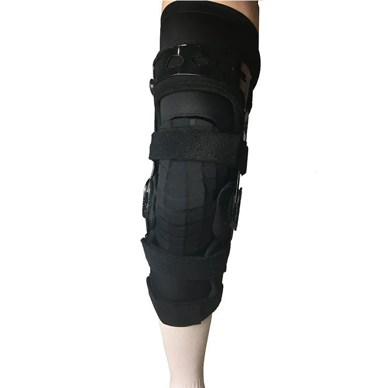 Black anterior ligament knee supporter with adjustable strap, shown on a knee.