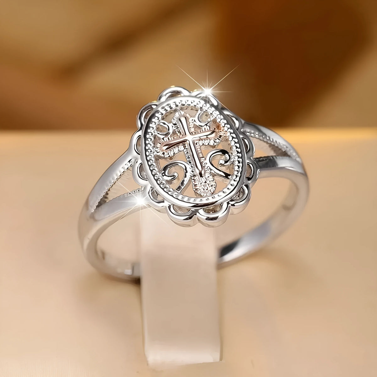 Silver colour women's cross lace ring on finger showing detailed design