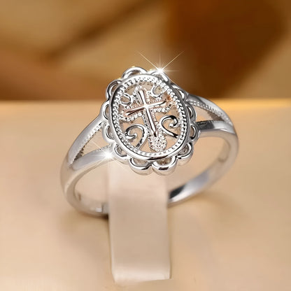 Silver colour women's cross lace ring on finger showing detailed design