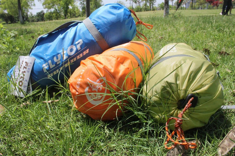 Double layer rainproof camping tent in green, orange, and blue colors for high altitude adventures