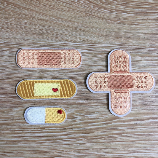 Pack of ten colourful embroidered fabric patch badges for sticking onto clothing.