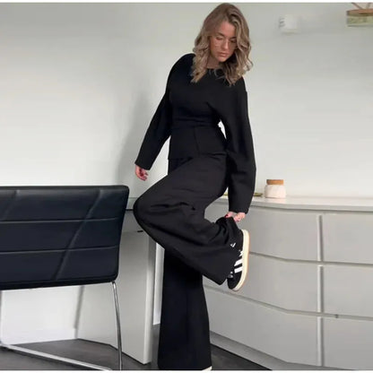 Women's black fleece tracksuit set featuring a pleated long sleeve top and wide leg trousers