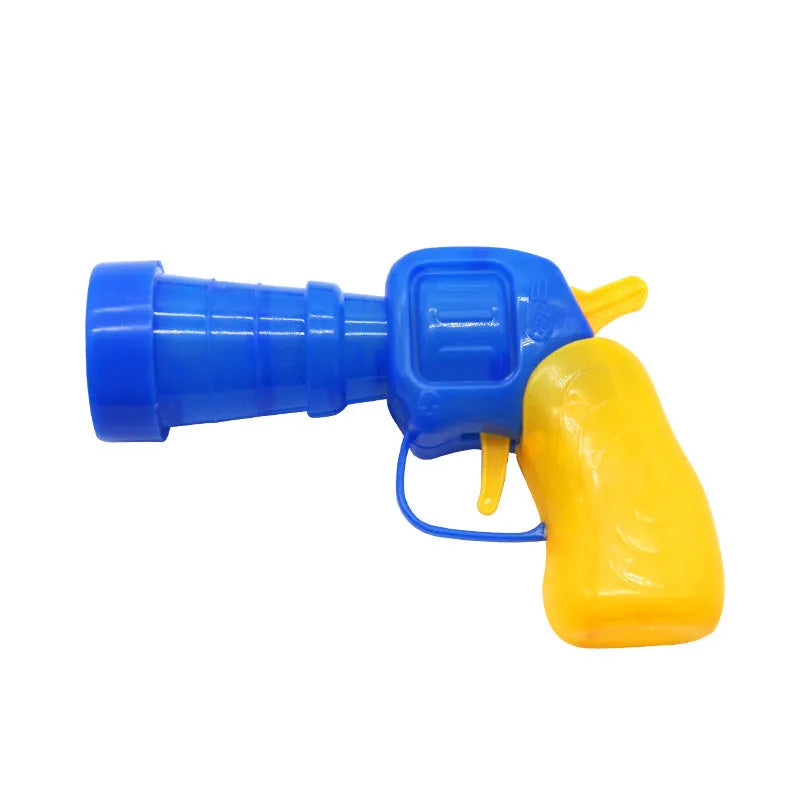 Interactive plastic pet toy gun and soft plush yarn balls on a carpet for fetch games.