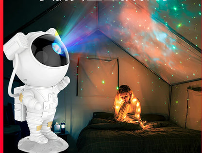 White astronaut-shaped night light projecting star patterns on ceiling with remote control