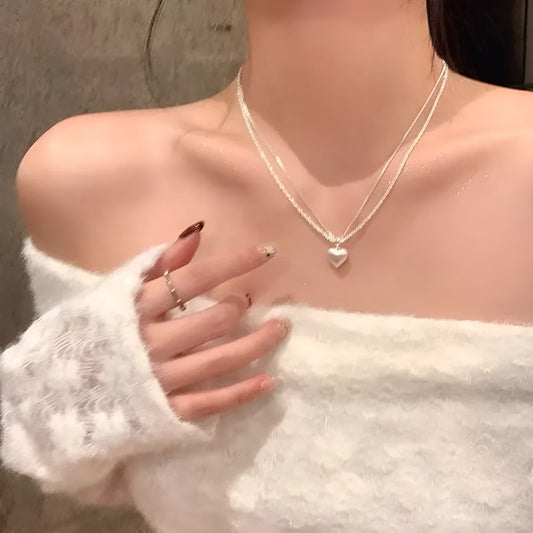 Double-layer brushed heart pendant necklace on adjustable silver-toned chain