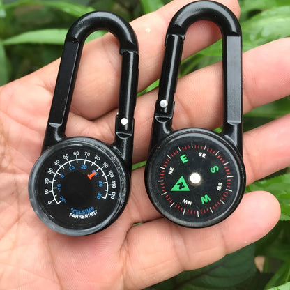 Black outdoor carabiner with a built-in circular compass and thermometer display on its side.