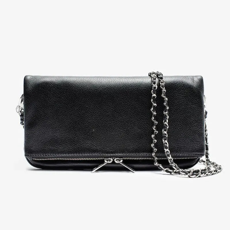 Soft black PU leather women's clutch bag with a gold chain strap, shown held and worn cross-body.
