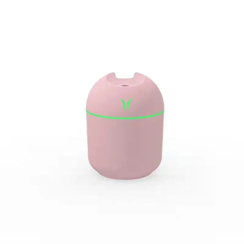 Mini round aromatherapy diffuser in ivory white with USB cable and essential oil bottle