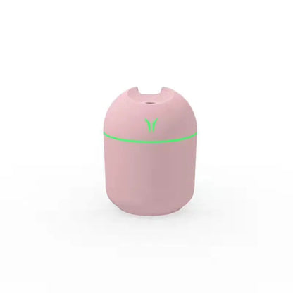 Mini round aromatherapy diffuser in ivory white with USB cable and essential oil bottle