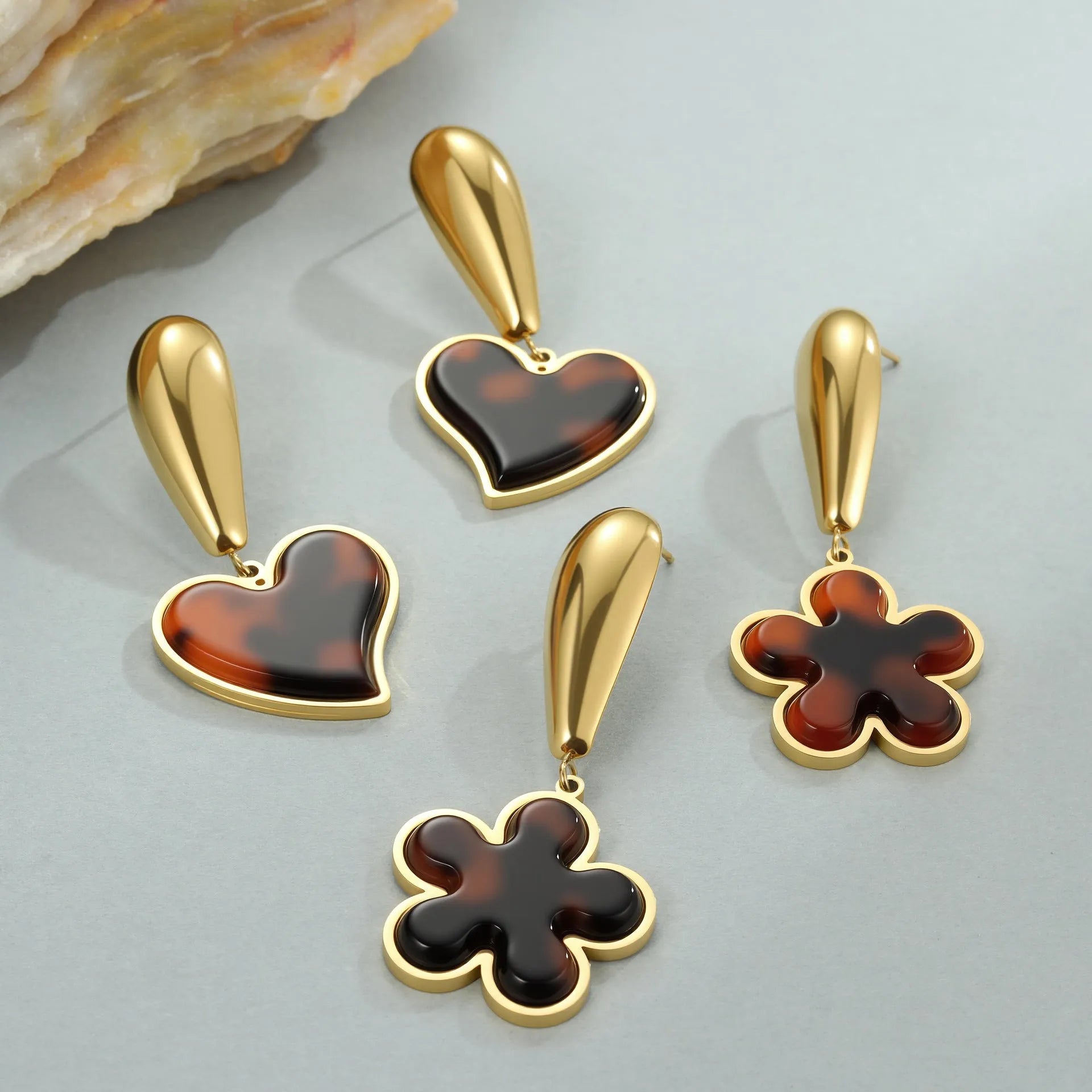 Women's tortoiseshell resin hawksbill colour earrings with 18K gold electroplating on stainless steel, showing heart-shaped and floral designs