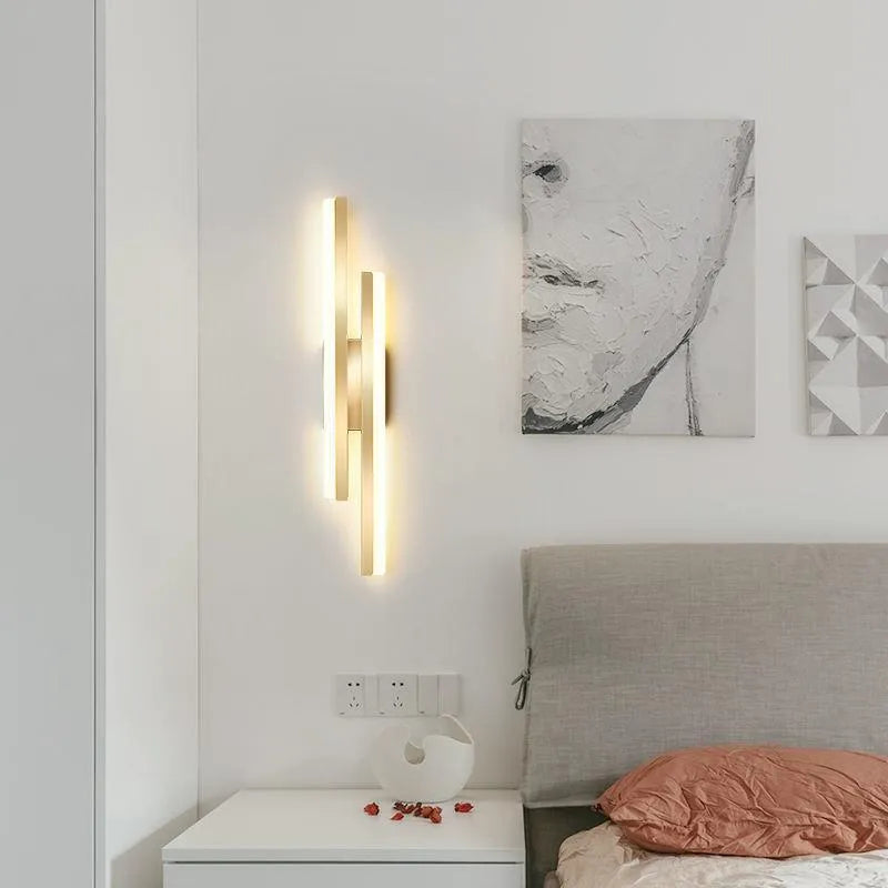 Scandinavian minimalist LED wall light with acrylic shade and adjustable arm in black or gold finish.