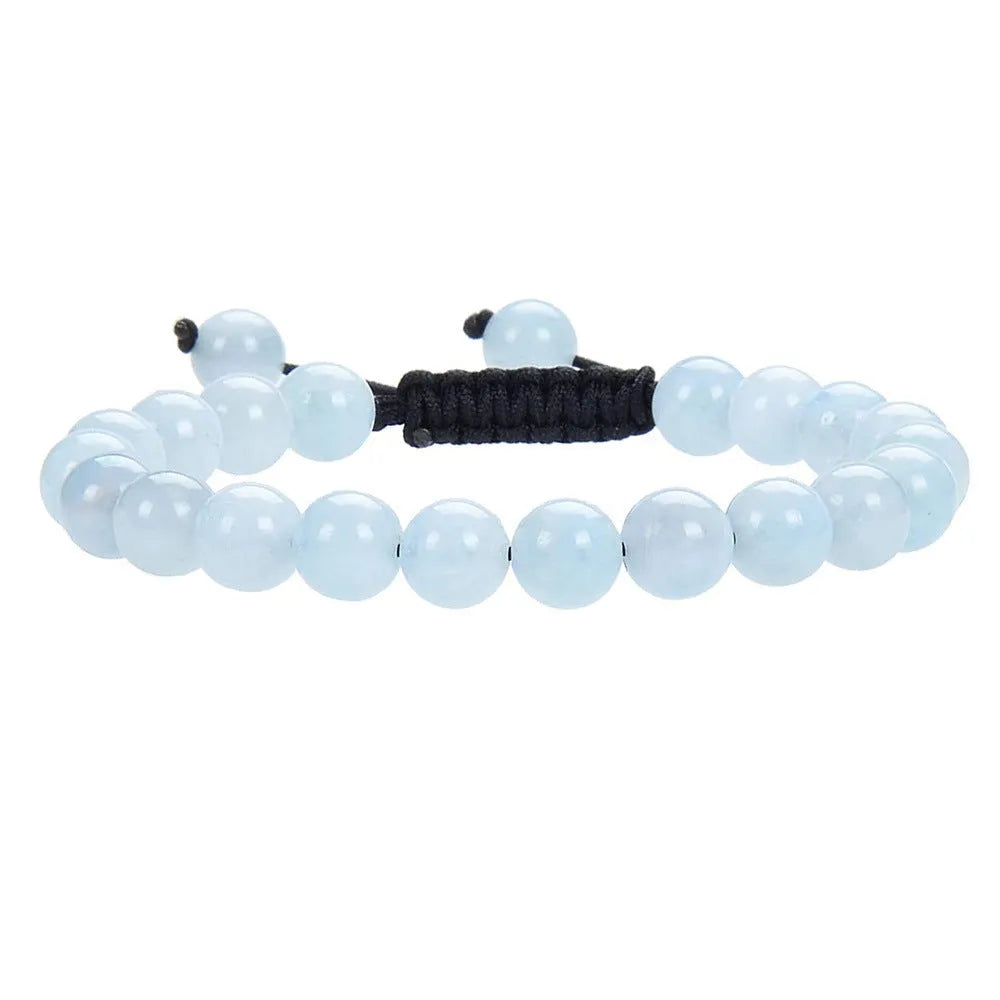 Close-up of a women's flat knot braided healing bracelet hand-woven with colourful gemstones.