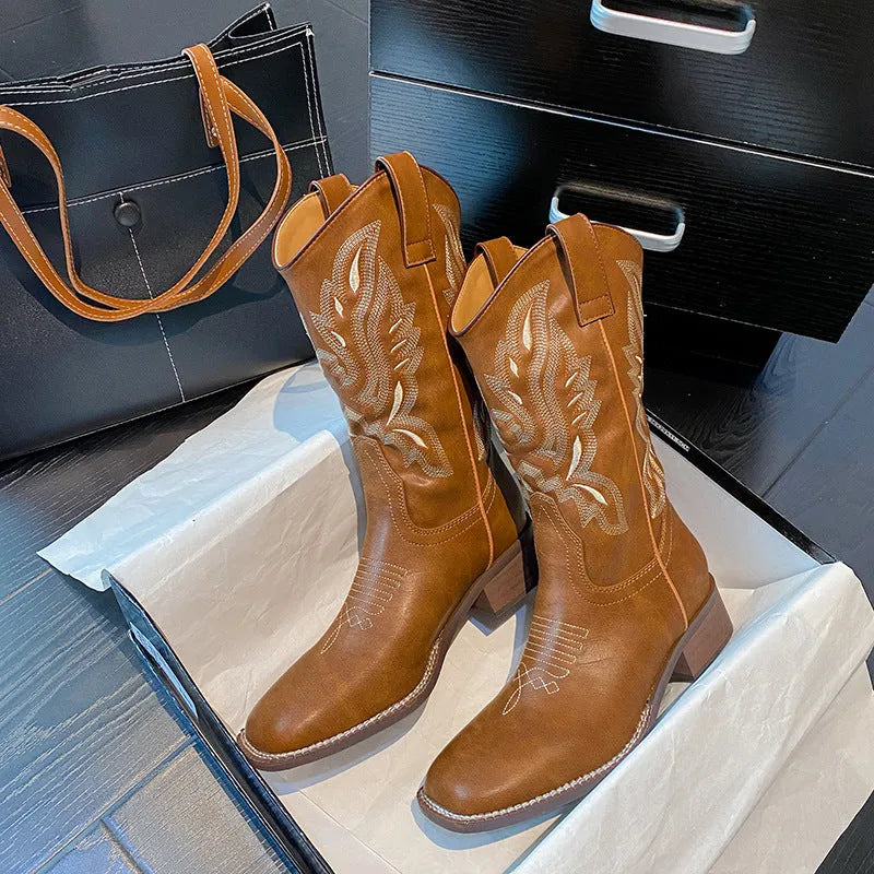 Brown women's mid-calf Martin boots with embroidered detail on the shaft.