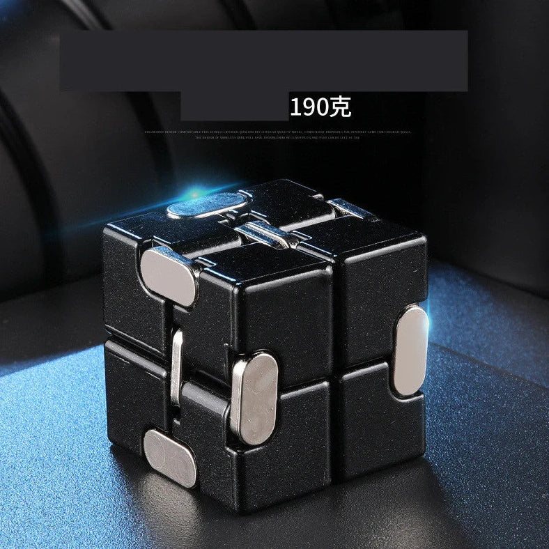 Zinc alloy Infinity Cube with eight rotating cubes showing black and silver colour options on wooden surface