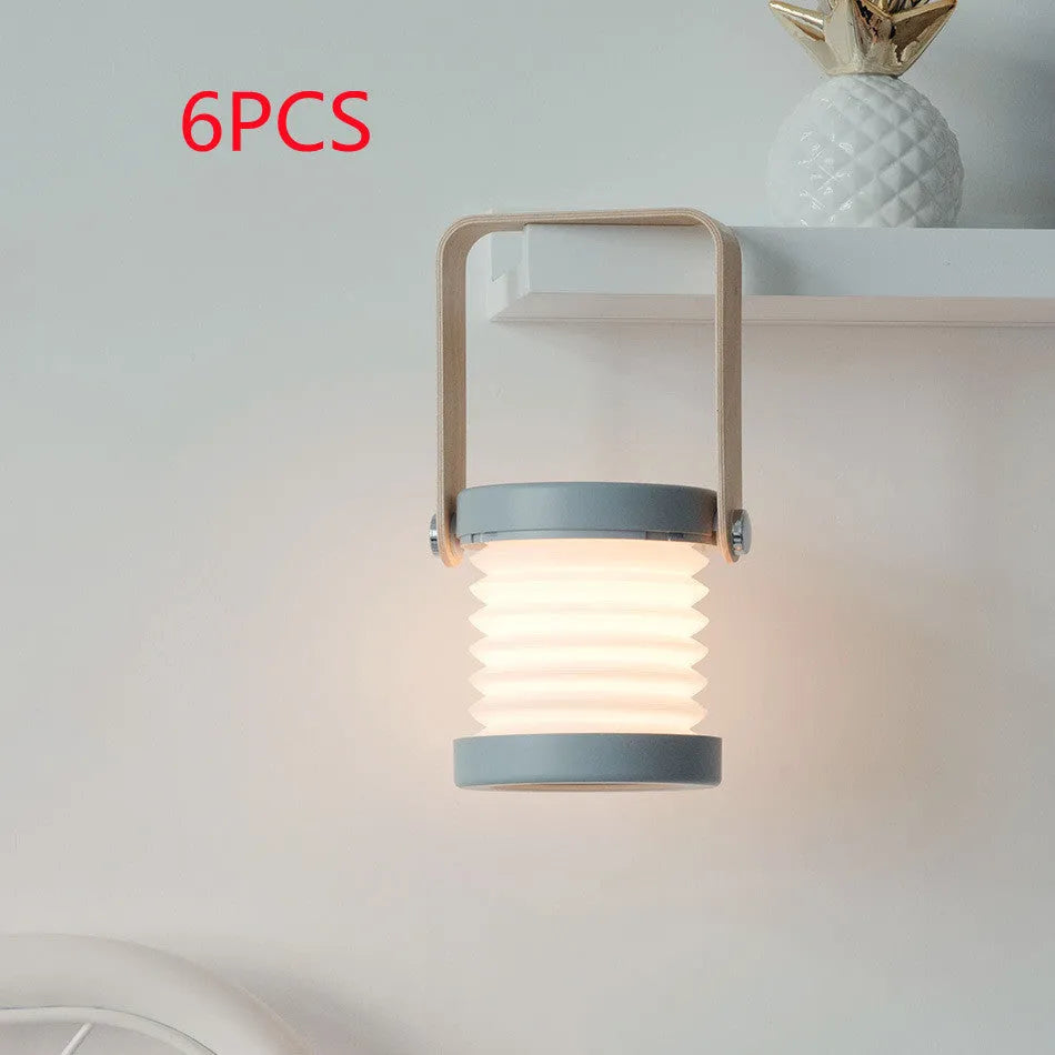 White foldable USB rechargeable LED night light in both table lamp and tall lantern modes.