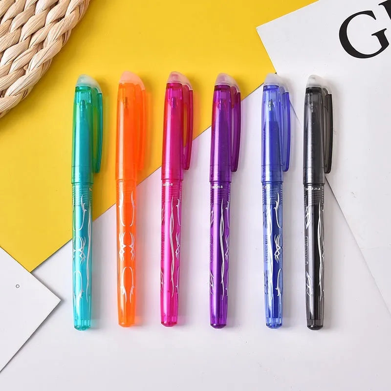 A set of hot erasable gel pens in multiple colours with plastic bodies and stainless steel nibs, shown with a hairdryer to illustrate the heat-erasable function.