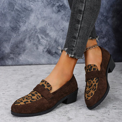 Leopard print slip-on suede pump shoe with chunky mid heel and pointed toe on a rubber sole.