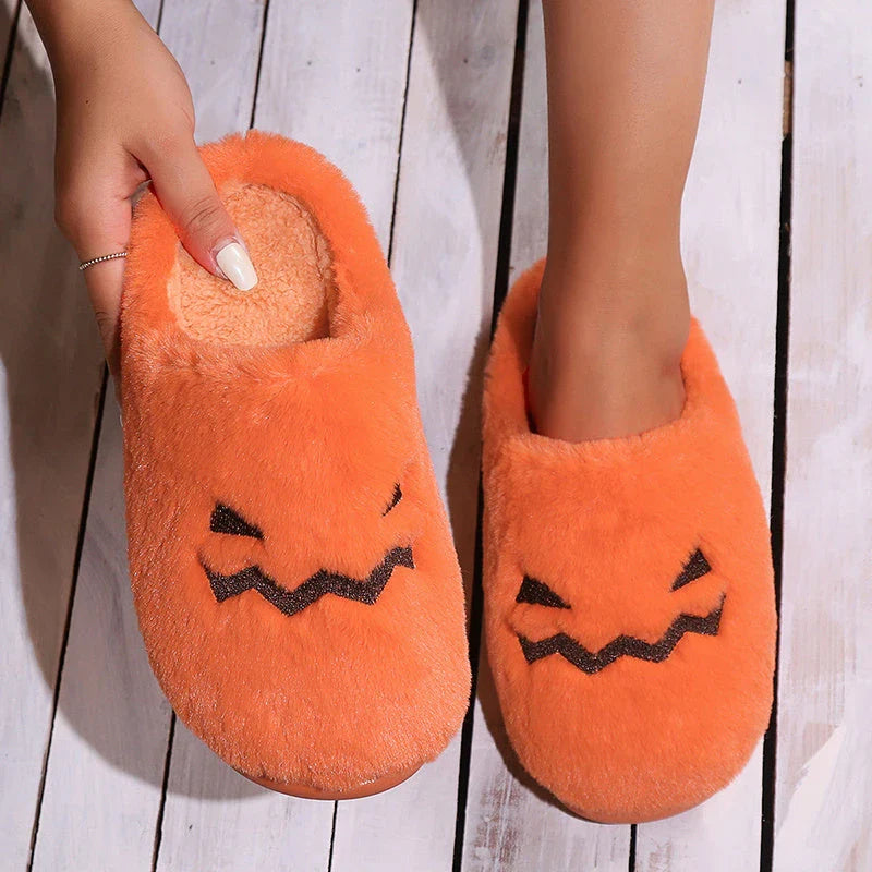 Cozy Halloween pumpkin-themed slippers with plush lining and non-slip soles for comfortable indoor wear