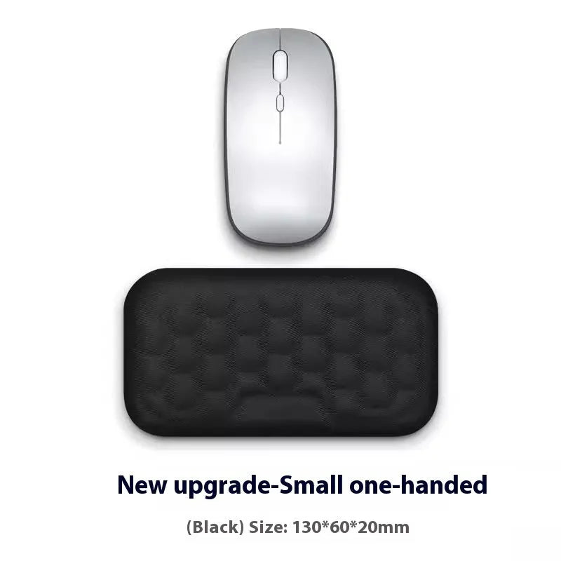 Black and grey memory foam mouse wrist rests with cloth and leather-style covers on a desk.
