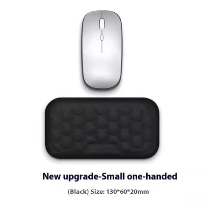Black and grey memory foam mouse wrist rests with cloth and leather-style covers on a desk.