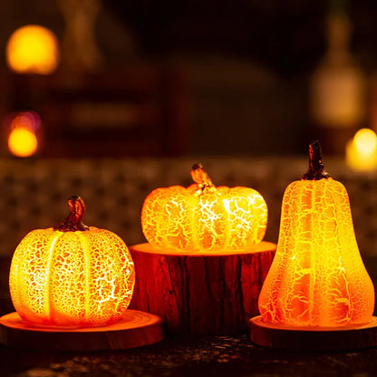 Set of three resin Halloween pumpkin lanterns with LED lights in long, medium, and short sizes.