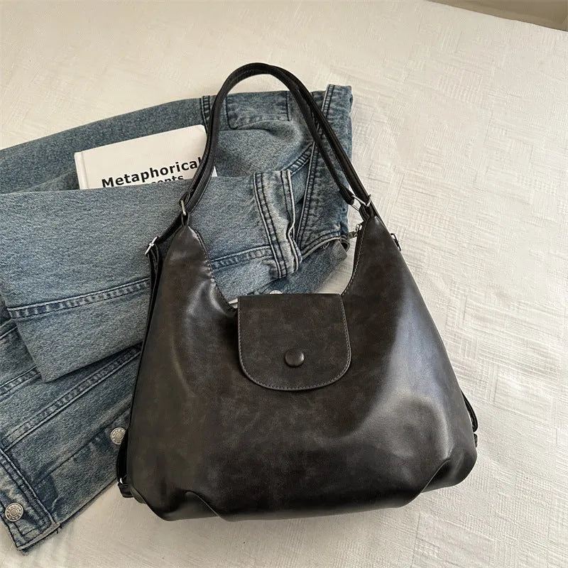 Textured PU leather women's shoulder bag in black with single strap and optional pendant